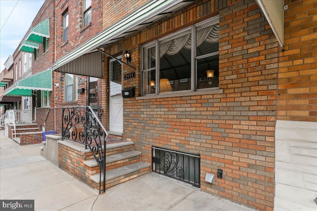 entrance to property with brick siding