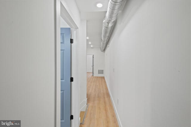 hallway with light hardwood / wood-style flooring