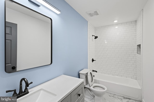 full bathroom with toilet, vanity, and tiled shower / bath combo