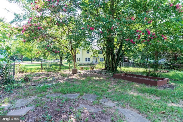 view of yard with fence and a garden