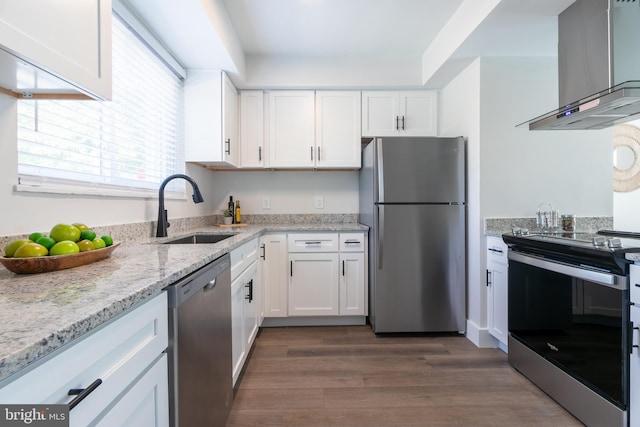 kitchen with island range hood, stainless steel appliances, a sink, white cabinets, and light stone countertops