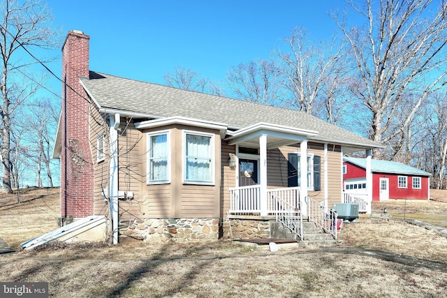 view of front of property with central air condition unit and a garage