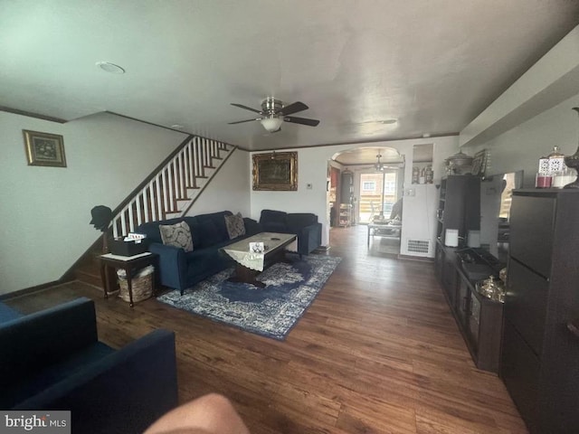 living room with dark hardwood / wood-style floors and ceiling fan