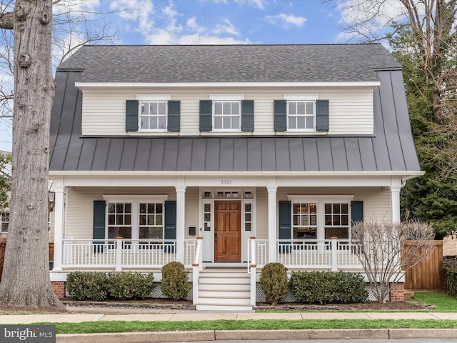 view of front of property featuring covered porch, a shingled roof, metal roof, and a standing seam roof