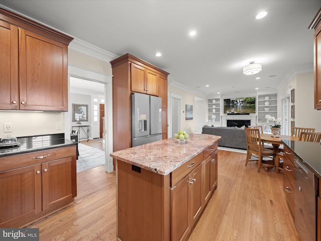 kitchen featuring light wood-style floors, stainless steel fridge, and crown molding