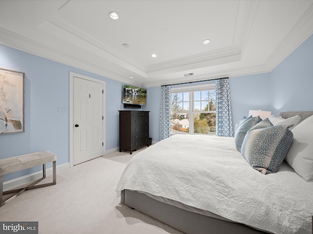 bedroom featuring light carpet, baseboards, a tray ceiling, and ornamental molding