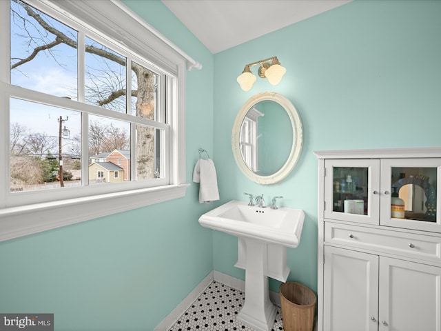 bathroom with baseboards, a sink, and tile patterned floors