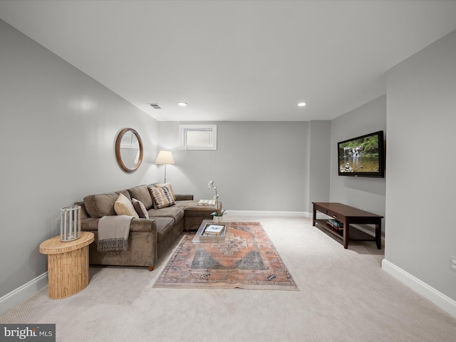 living room featuring recessed lighting, baseboards, and light colored carpet