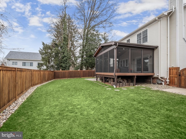 view of yard with a sunroom and a fenced backyard