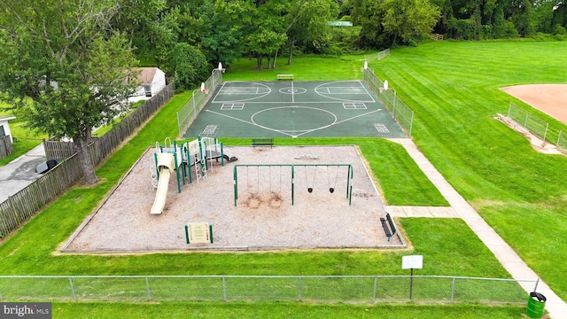 exterior space featuring community basketball court, a yard, playground community, and fence