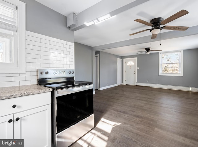 kitchen featuring light stone countertops, decorative backsplash, dark hardwood / wood-style flooring, white cabinetry, and stainless steel electric stove