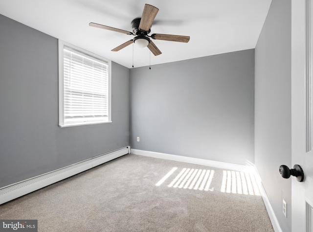 carpeted empty room with baseboard heating and ceiling fan