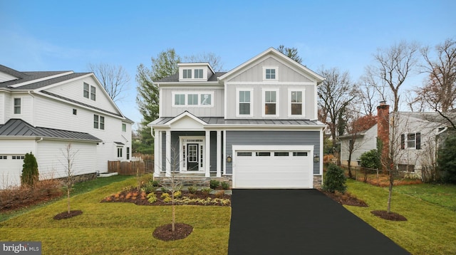 view of front of property featuring a standing seam roof, a front yard, board and batten siding, and fence