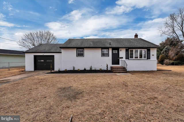 ranch-style home featuring brick siding, driveway, a chimney, and an attached garage