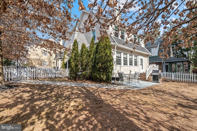 rear view of house featuring a patio area and fence