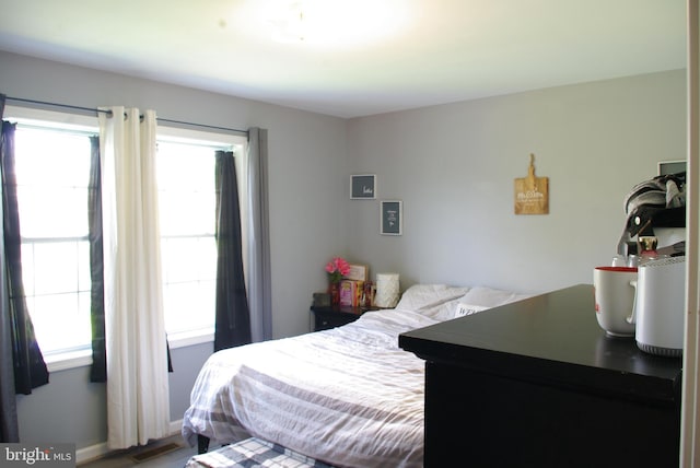 bedroom featuring multiple windows and baseboards