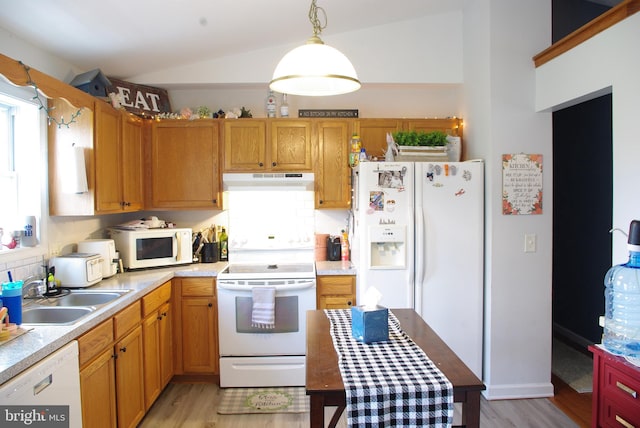 kitchen featuring white appliances, light wood-type flooring, a sink, lofted ceiling, and under cabinet range hood