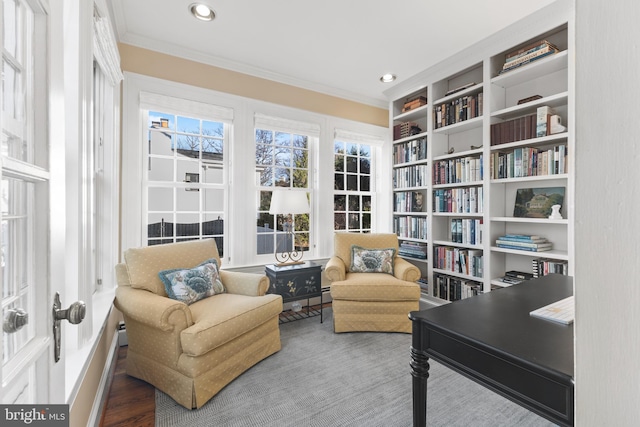 living area featuring crown molding