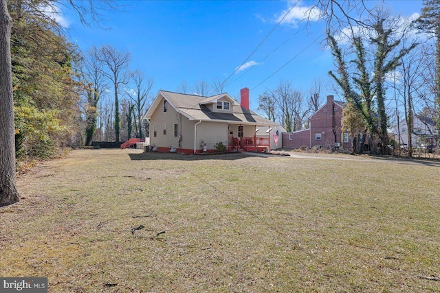 view of home's exterior featuring a yard and a chimney