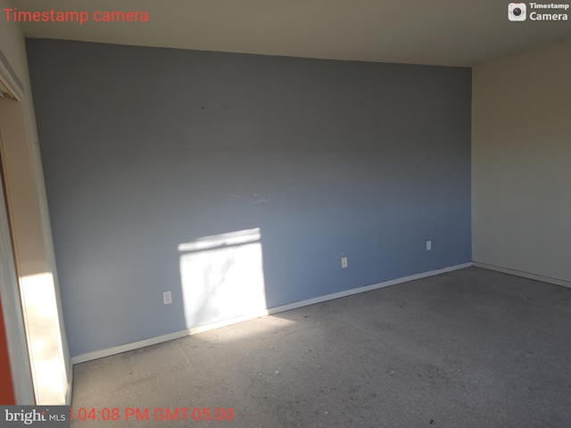 spare room with baseboards