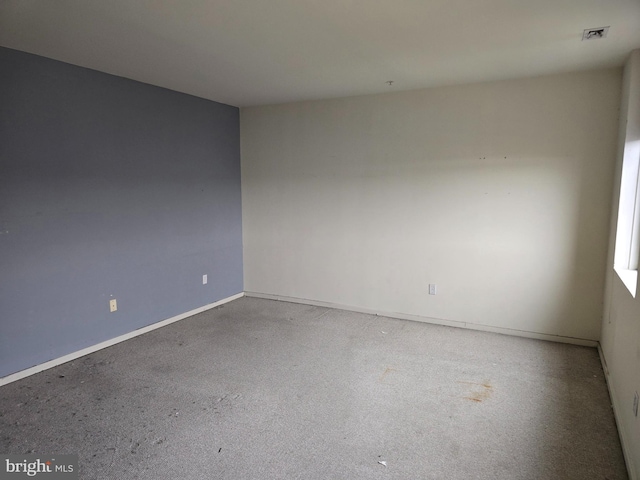 unfurnished room featuring visible vents and baseboards