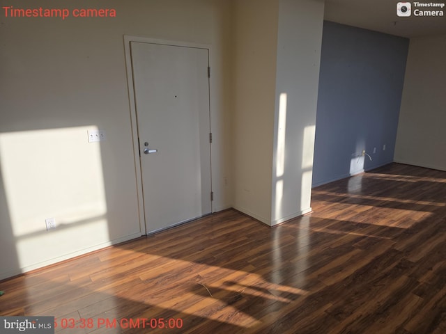 empty room with dark wood-style flooring