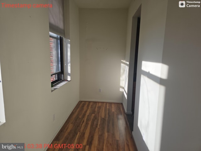 hall featuring dark wood finished floors and baseboards