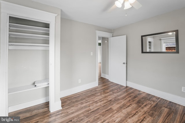 unfurnished bedroom with ceiling fan, dark hardwood / wood-style floors, and a closet