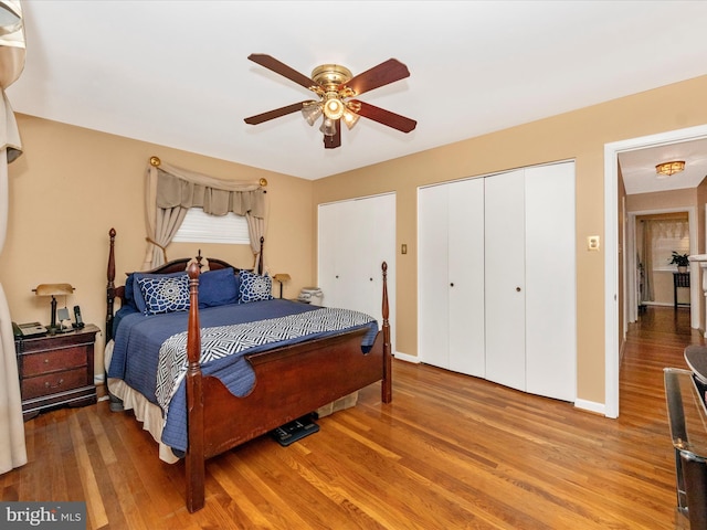 bedroom with a ceiling fan, baseboards, and wood finished floors