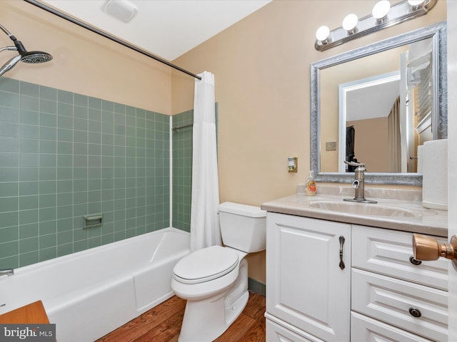 bathroom featuring shower / bath combo, vanity, toilet, and wood finished floors