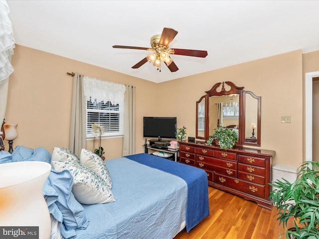 bedroom with light wood-style floors and a ceiling fan