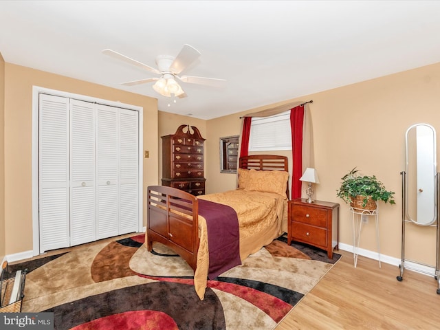 bedroom with a ceiling fan, a closet, baseboards, and wood finished floors