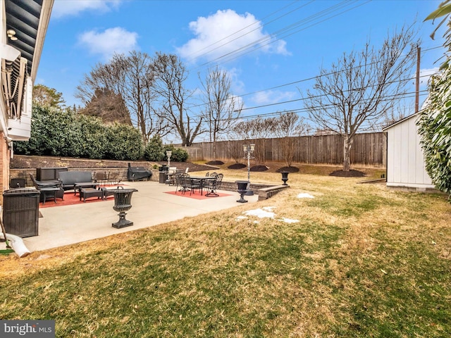 view of yard with a storage shed, a patio, a fenced backyard, an outdoor structure, and an outdoor living space