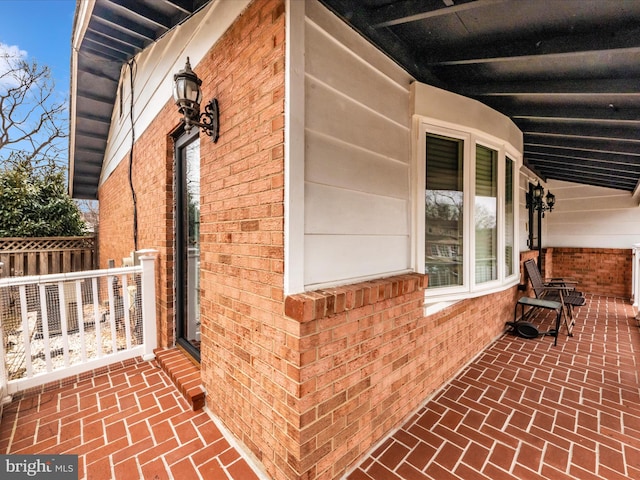 view of side of home with brick siding