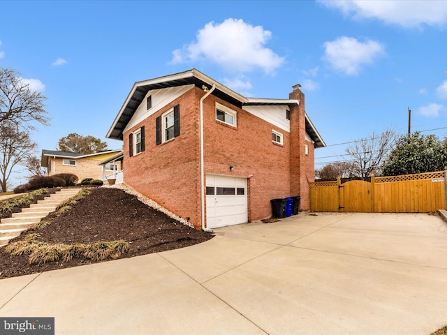 view of property exterior with brick siding, a chimney, stairway, an attached garage, and driveway