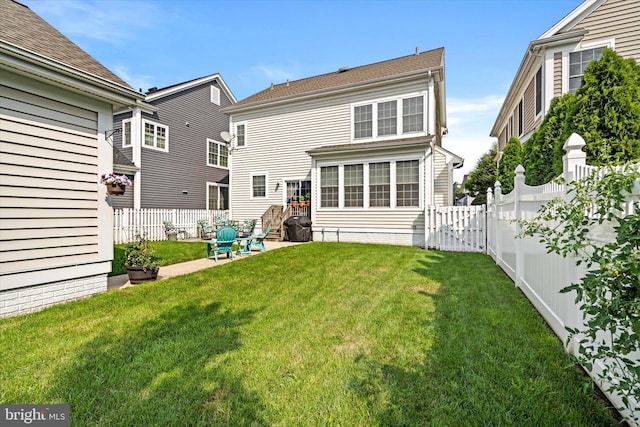 back of property featuring a lawn and a patio area