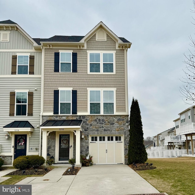 multi unit property with a front yard and a garage