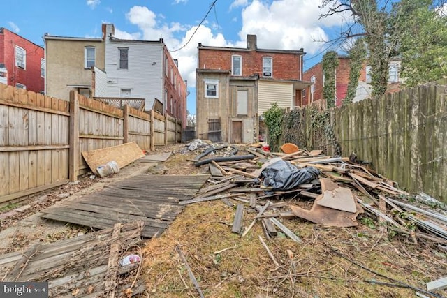 rear view of house with a fenced backyard