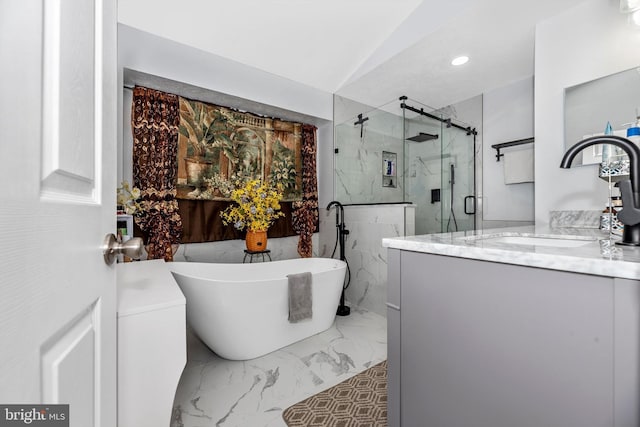 bathroom with recessed lighting, vanity, a freestanding bath, marble finish floor, and a marble finish shower