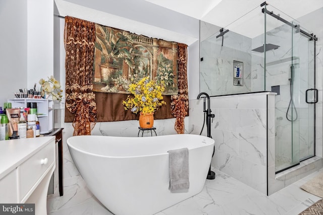 bathroom with marble finish floor, a soaking tub, vanity, and a marble finish shower