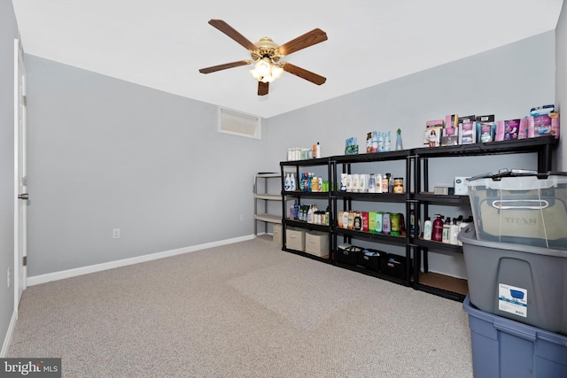 interior space with carpet floors, ceiling fan, and baseboards