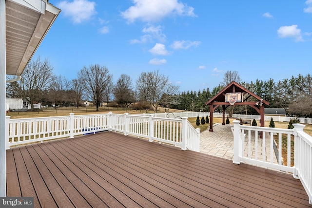 wooden terrace with a fenced backyard and a gazebo