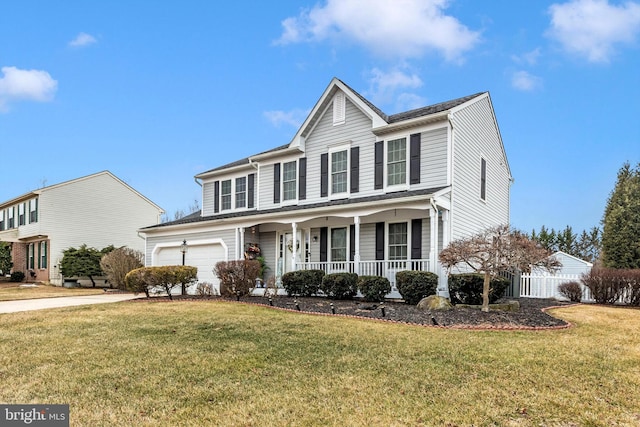 traditional home featuring covered porch, a garage, fence, driveway, and a front yard