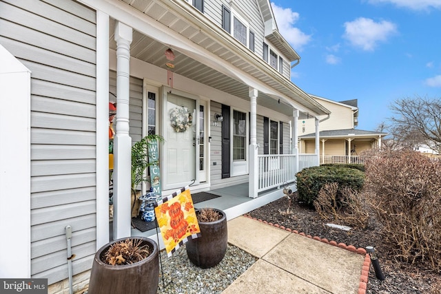 view of exterior entry with covered porch