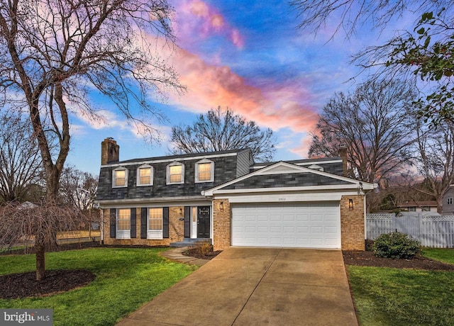 view of front of home with an attached garage, brick siding, fence, a yard, and a chimney