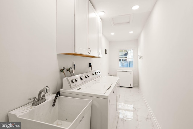 washroom featuring cabinet space, baseboards, marble finish floor, separate washer and dryer, and a sink