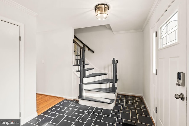 entryway with baseboards, stairway, and crown molding