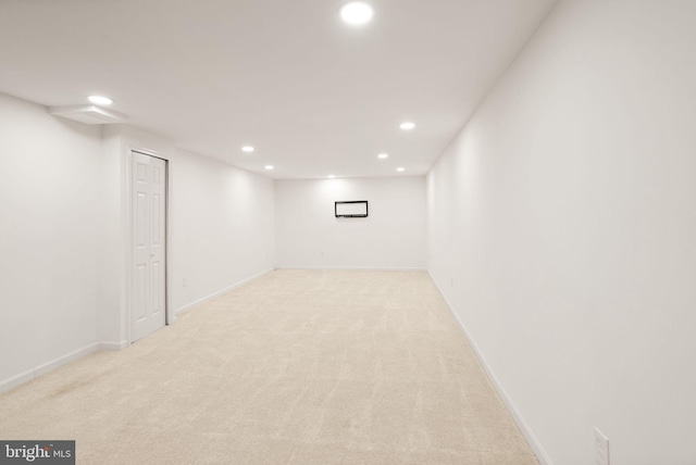 finished basement with baseboards, light colored carpet, and recessed lighting