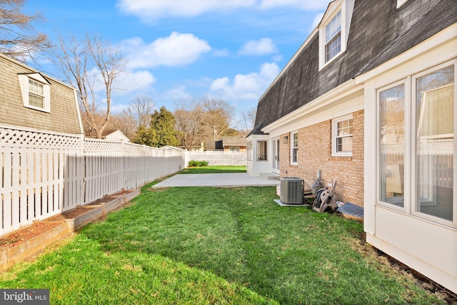 view of yard with a patio area, a fenced backyard, and central air condition unit