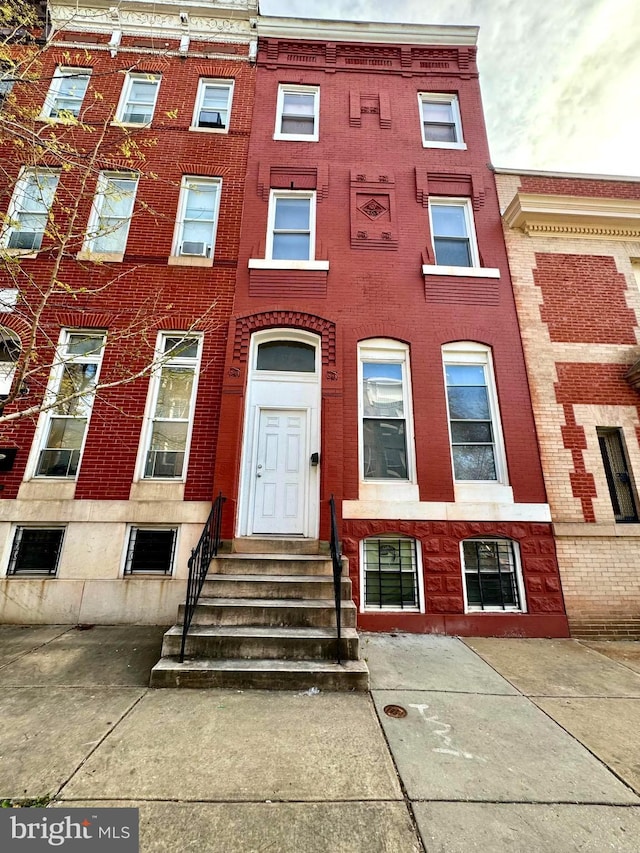 multi unit property featuring brick siding and entry steps